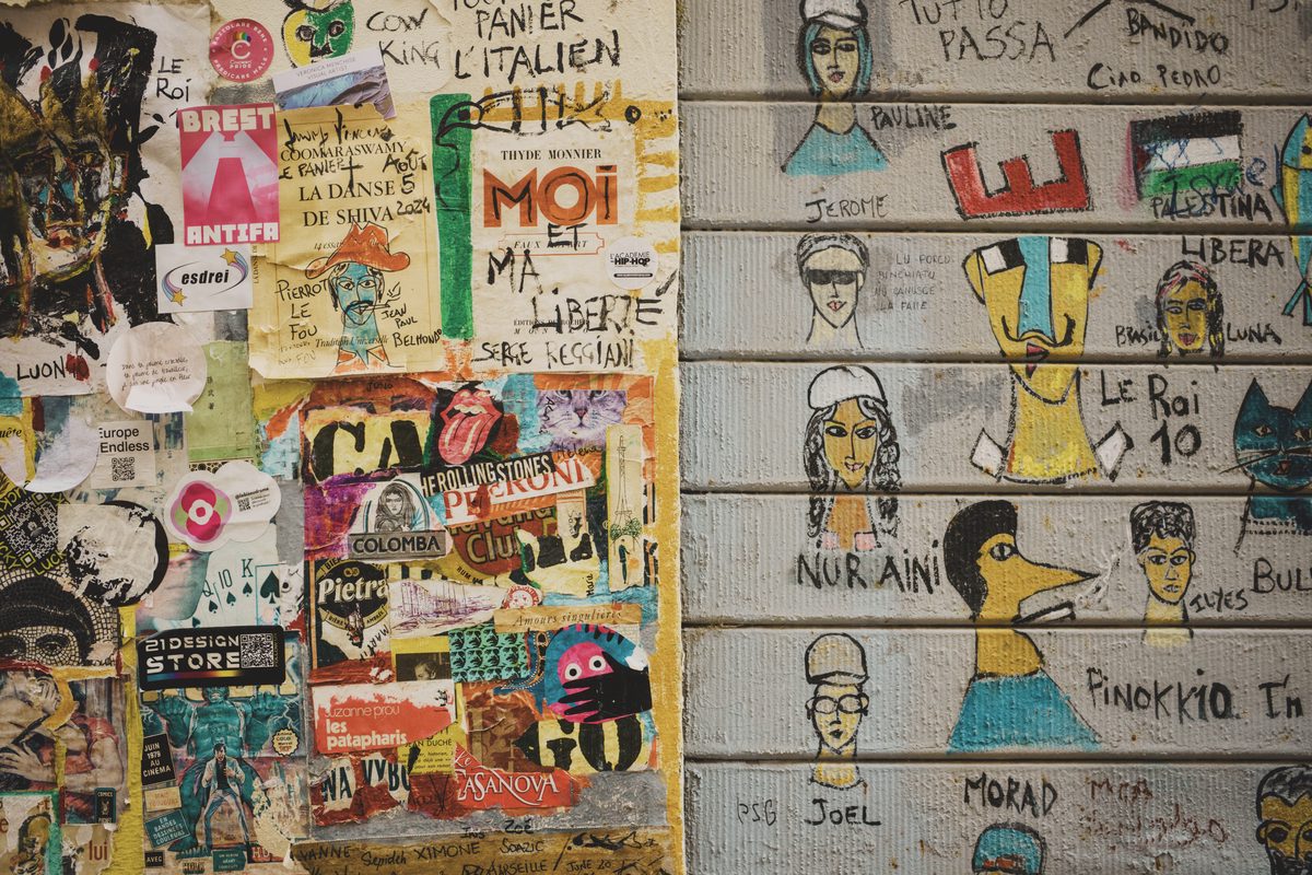 A wall covered with posters and graffiti. Image Anthony Nelzin-Santos.