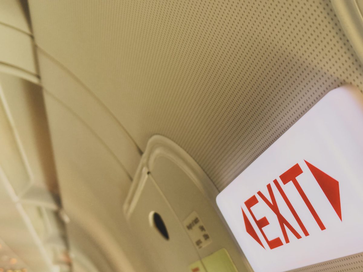 An exit sign on a plane. Image Anthony Nelzin-Santos.