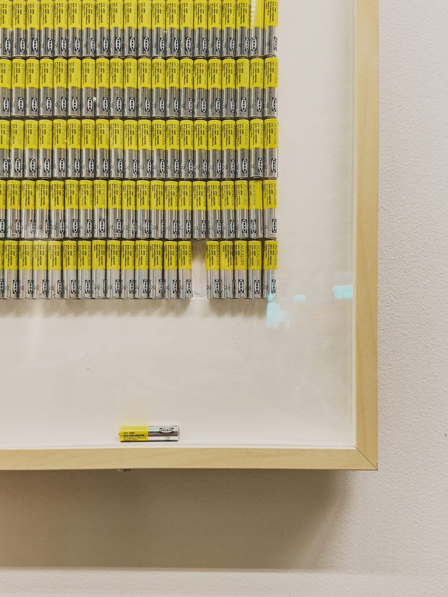A lone battery that’s fallen down from a row of batteries in some sort of art installation in an IKEA store.