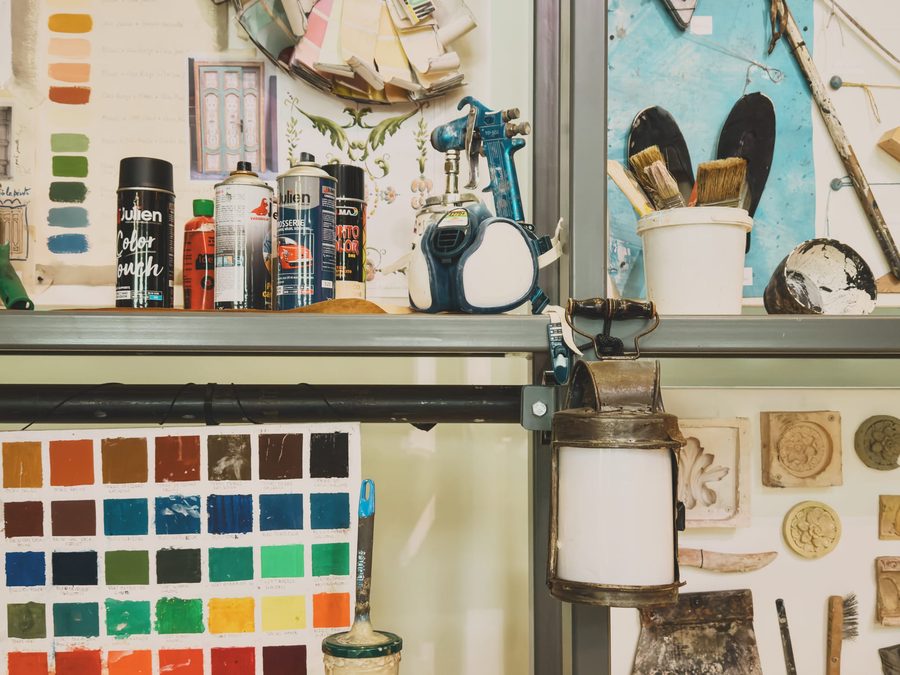 An assortment of colour swatches and paints on shelves.